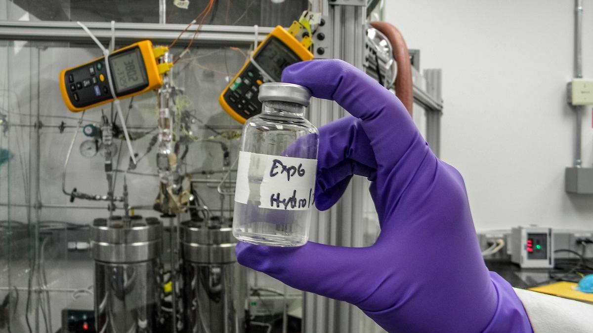 A research vial held in a chemistry laboratory illustrating suramin and antipurinergic therapy research — a Panacea Bio Chem page by Bogdan Dicoias